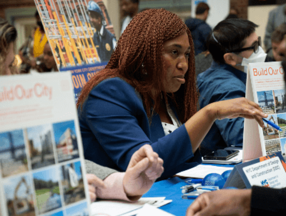 Participants at a job fair learning more about city employment